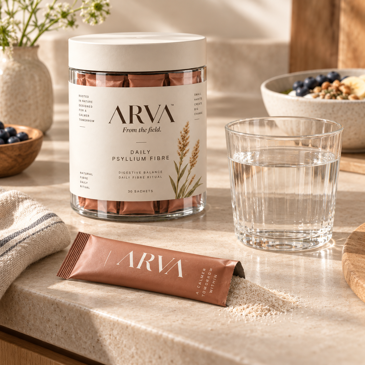 An opened Arva sachet poured out beside a glass of water on a kitchen counter