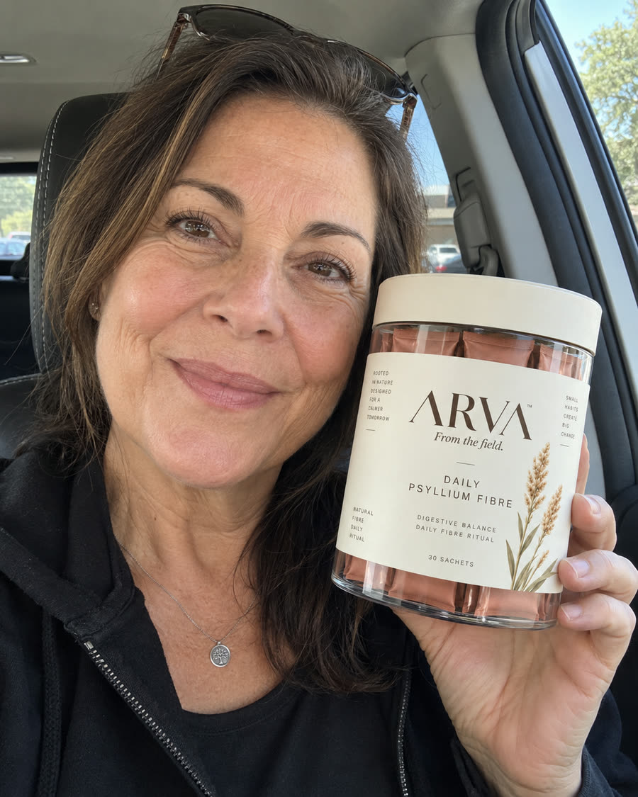 Woman holding a jar of Arva Daily Psyllium Fibre