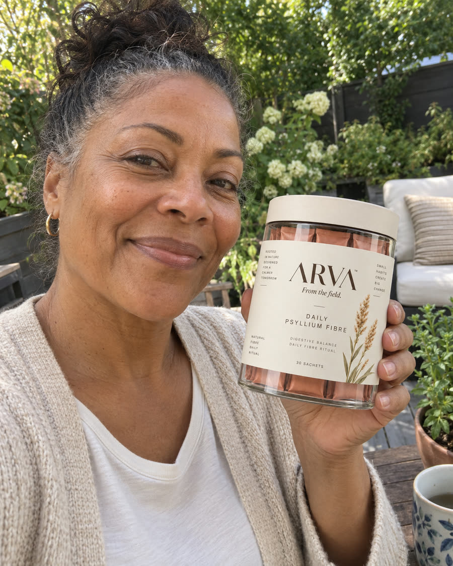 Woman in a garden holding a jar of Arva Daily Psyllium Fibre