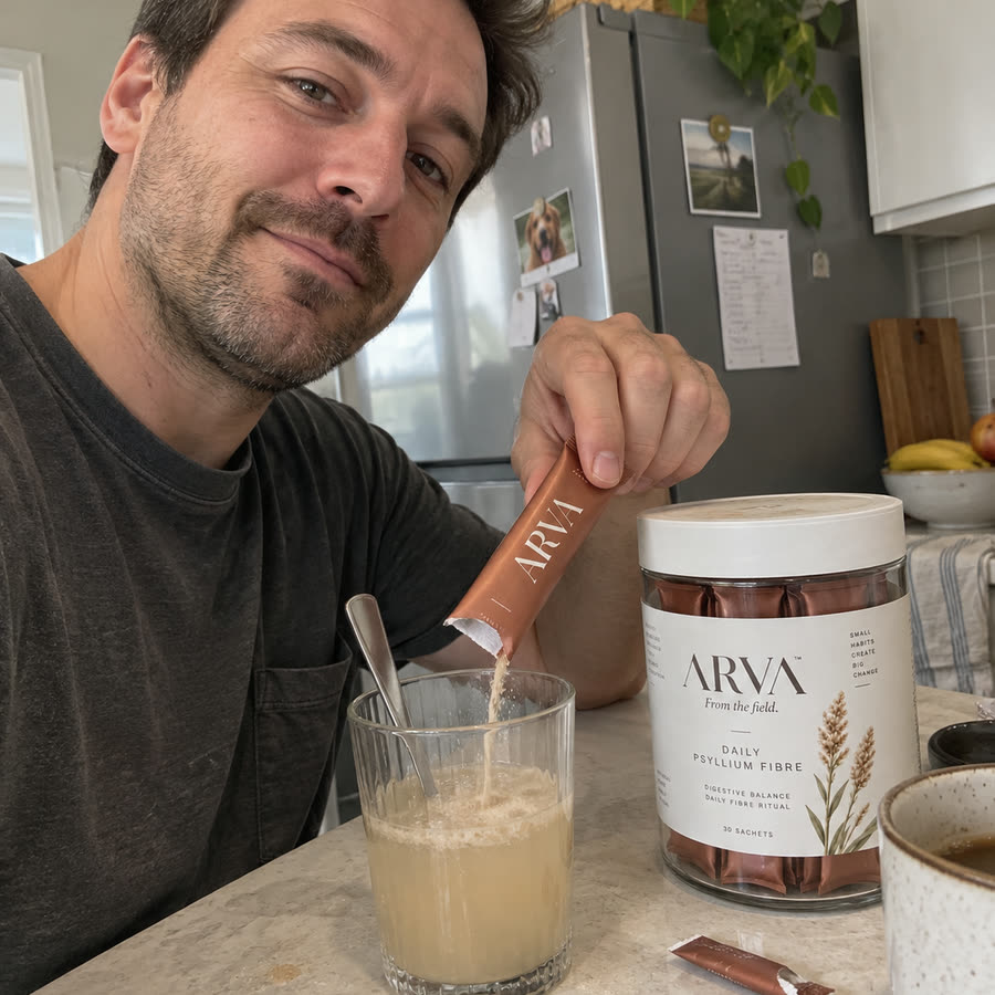 Ben stirring an Arva sachet into a glass of water at his kitchen counter